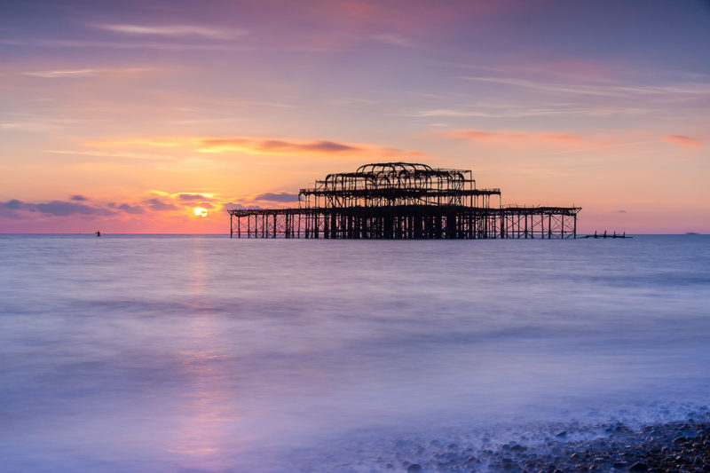 Sunset Over Remains of Old Brighton Pier Sunset Over Remains of Old Brighton Pier1 Photograph by Tim Jackson
