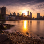 Brooklyn Bridge from Day to Dusk Sun Sets Behind Lower Manhattan Photograph by Tim Jackson