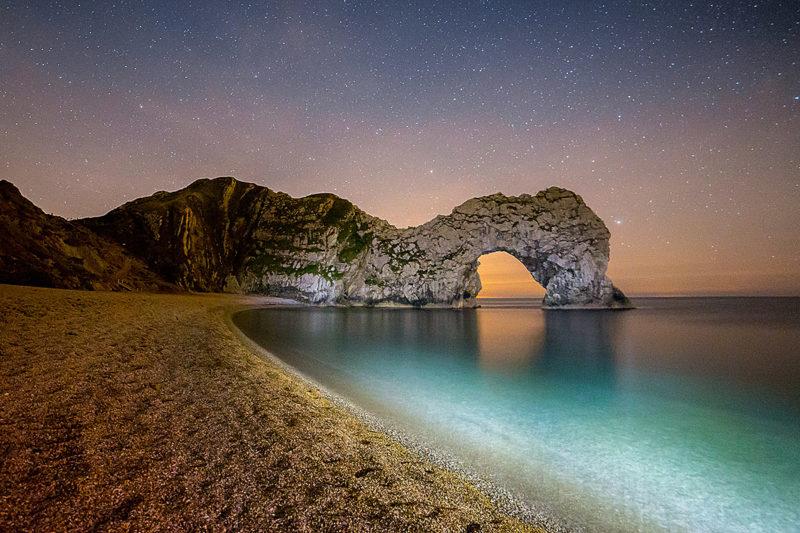 Lighting The Way to Durdle Door Lighting The Way to Durdle Door Photograph by Tim Jackson